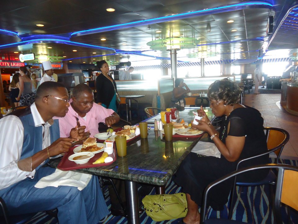 Mami and Pa Ade Xwith son Rev AdeX eating breakfast on a boat to the Carribean Islands